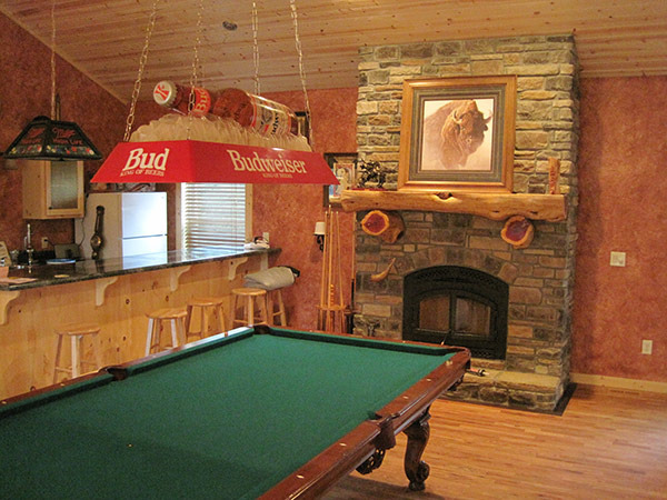 Custom home interior with cedar log mantel