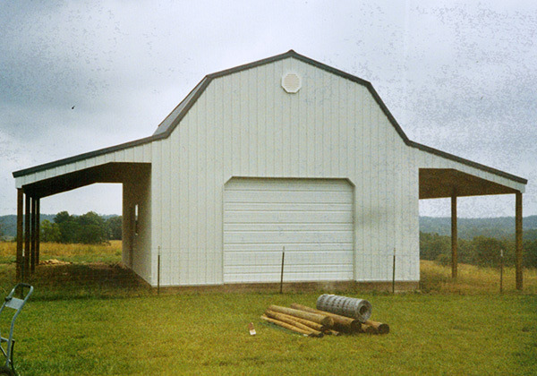 Framed, gambrel roof garage with open-pole sheds