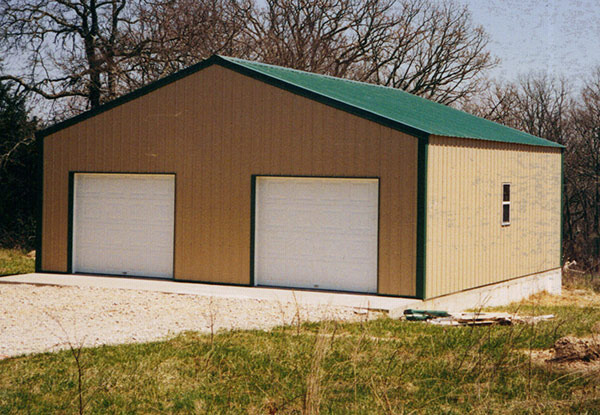Framed garage on slab with overhead doors