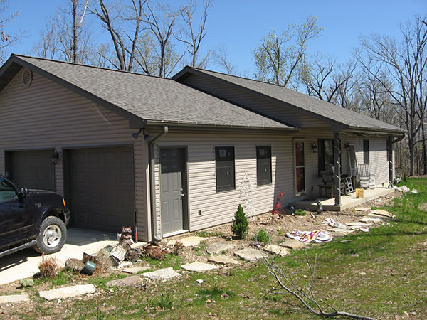 Custom home with vinyl siding and shingle roof